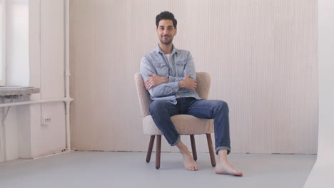 Dark-Haired-Man-Sitting-On-A-Chair