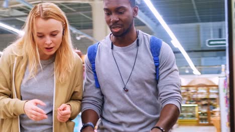 engaging in a shopping experience: a diverse pair exploring products together in a retail environment filled with aisles and goods