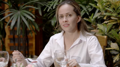 young woman having dinner in restaurant