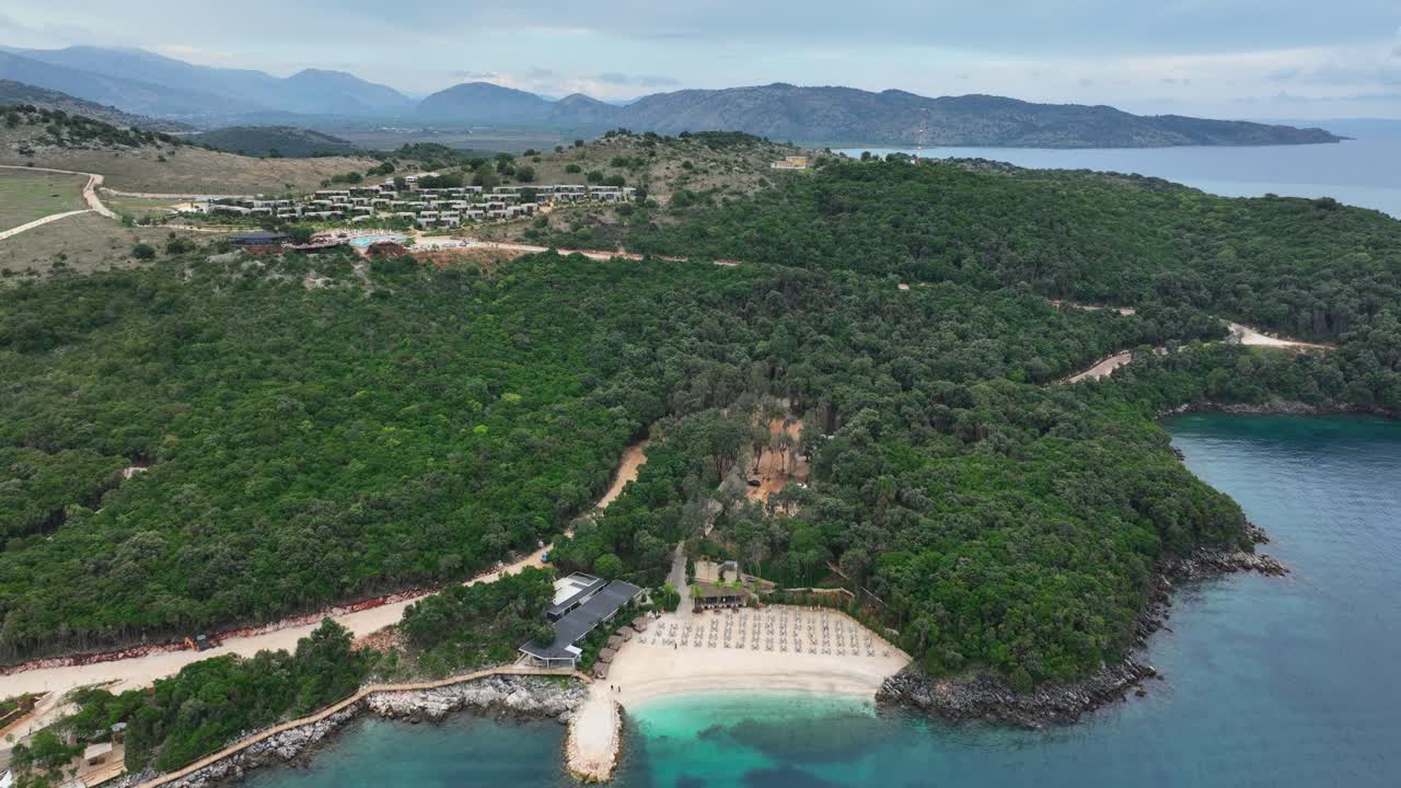 reathtaking aerial view of a picturesque tourist area in Albania, featuring beautiful beaches, clear turquoise waters, lush greenery, and inviting coastal landscapes.