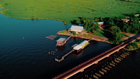aerial drone of lakeside boathouses and marshland cottages on lake pontchartrain, louisiana