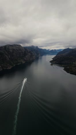 eerie boat going through the water between the rocky hills