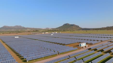 forward aerial push over rows of solar panels in large solar field