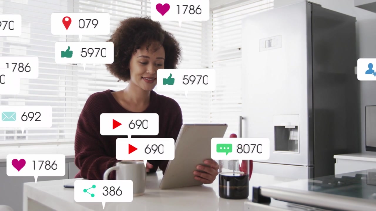 Vertical video: Woman tapping tablet checking social media alerts popping near tablet and mug