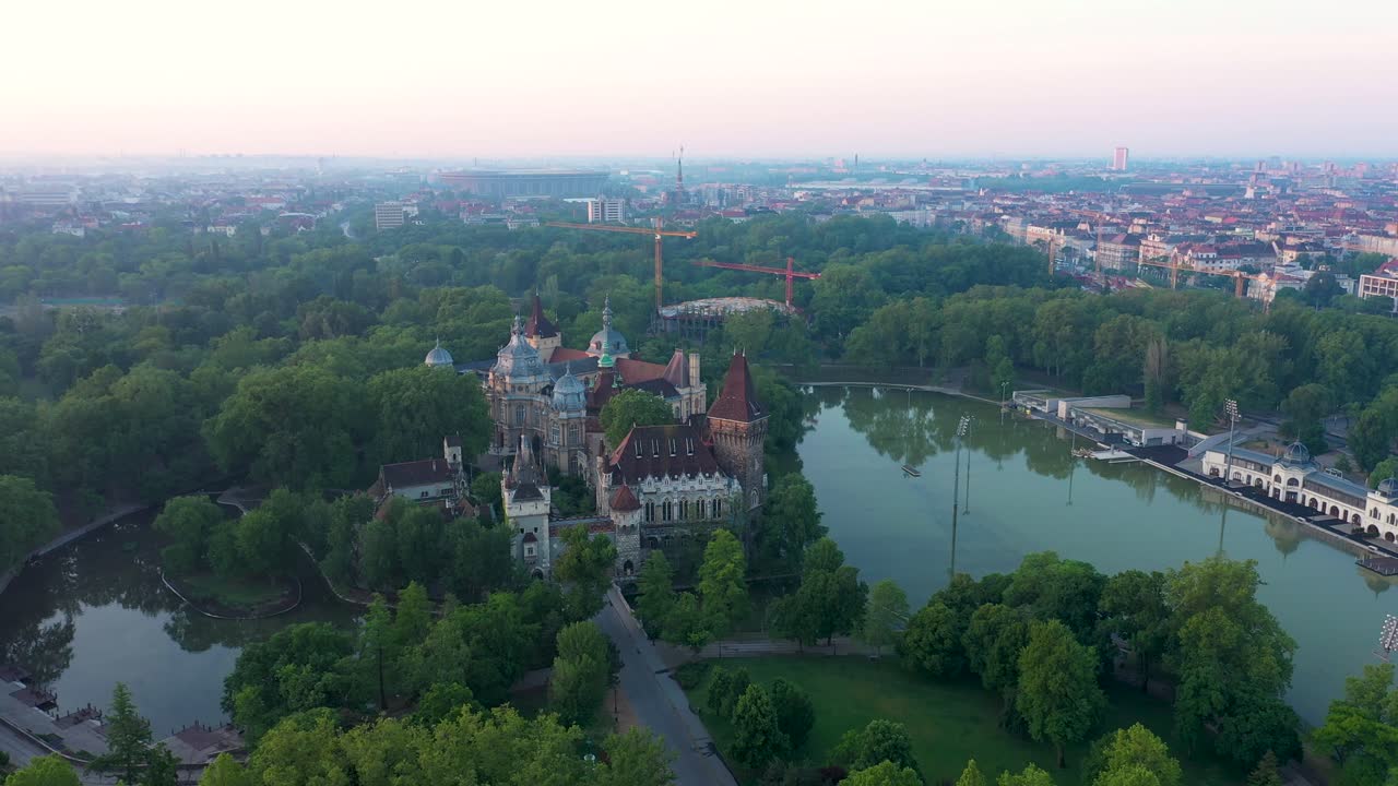 Drone footage from the Vajdahunyad castle at sunrise early morning in the empty Budapest. 
Drone circles slowly.