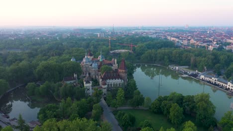 drone footage from the vajdahunyad castle at sunrise early morning in the empty budapest. 
drone circles slowly.