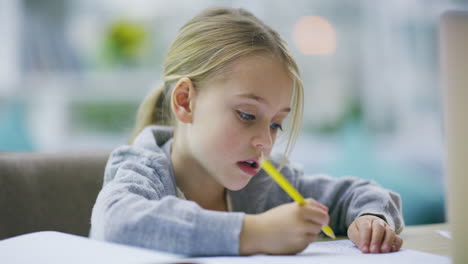 an-adorable-little-girl-doing-her-homework-at-home
