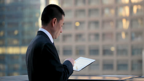 Side-view-of-young-Asian-Businessman-working-on-digital-tablet-4k