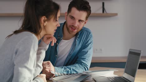 close up of caucasian couple designing new house ideas on computer