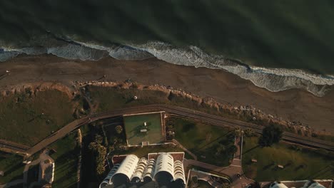 Top-down-view-flyover-of-apartments-near-the-coastline