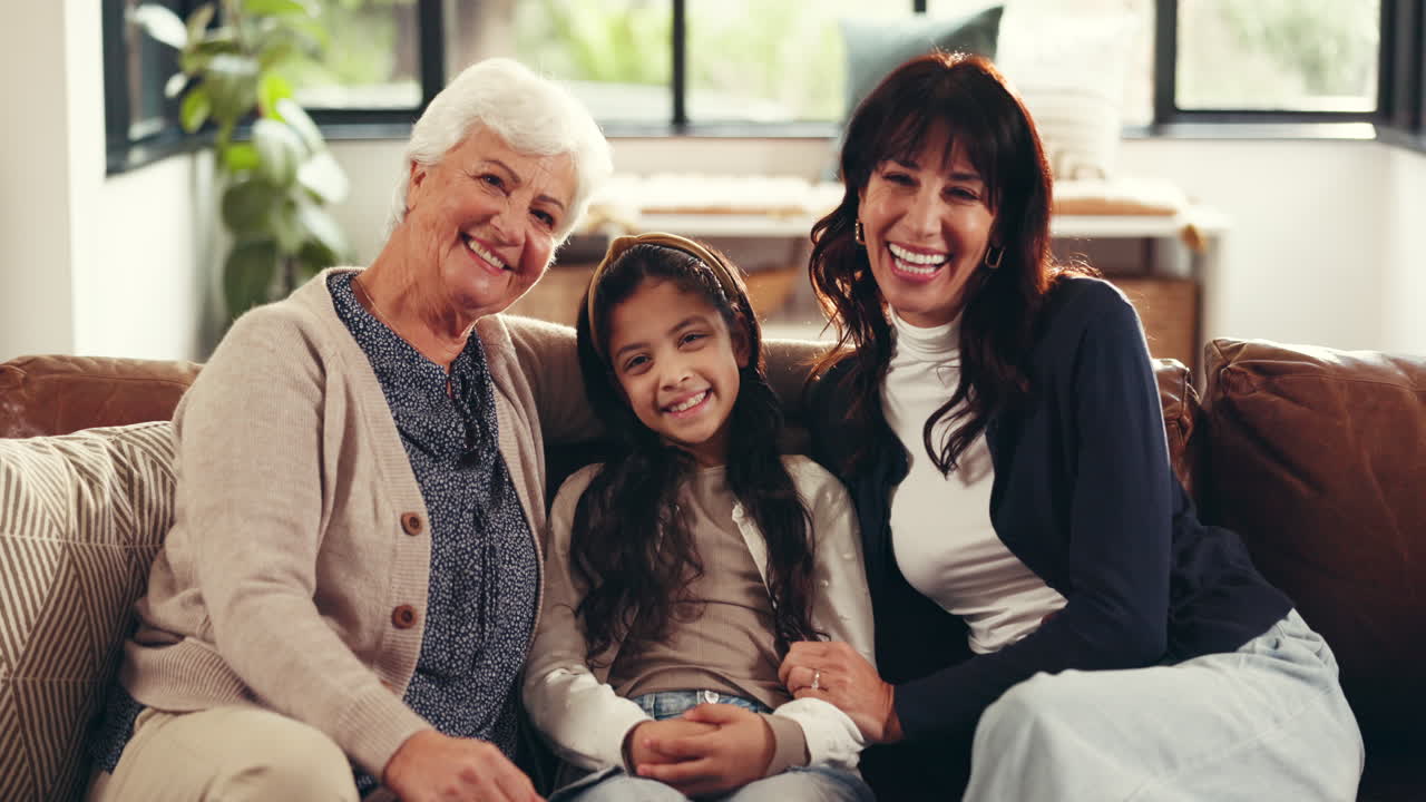 Three generations of women smiling together at home