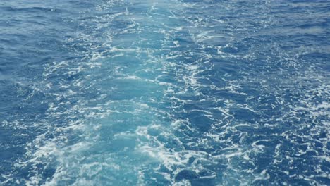 water foaming behind a boat