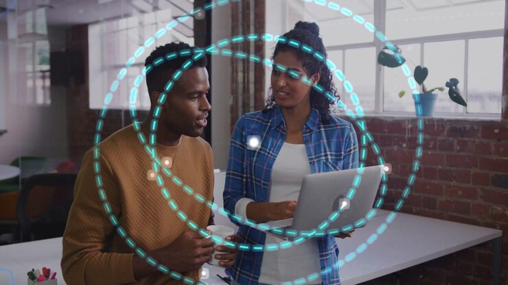 Woman holding laptop, man with mug, starting demoing in tech while glowing point forming cyan rings