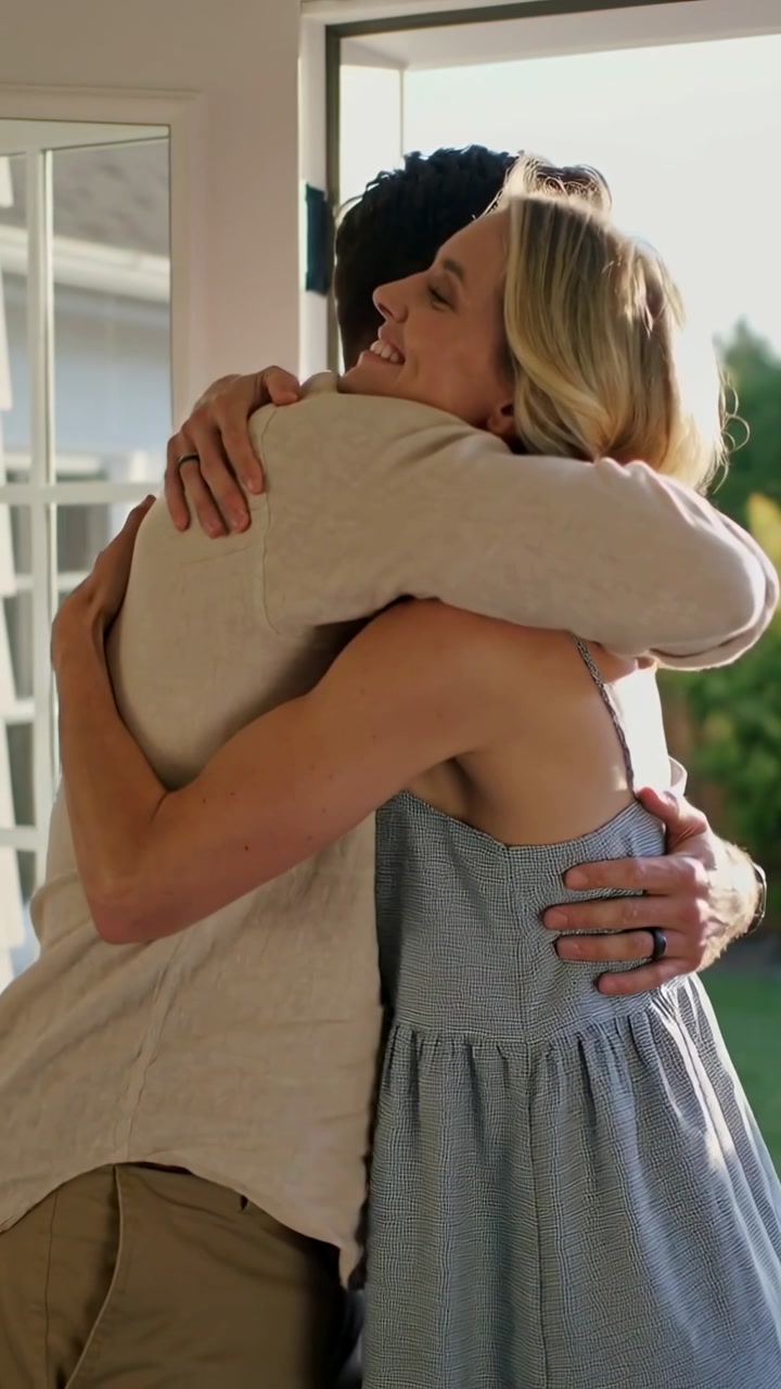 Happy Couple Hugging and Smiling Outdoors on a Sunny Day
