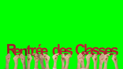 las manos sosteniendo rentree des clases
