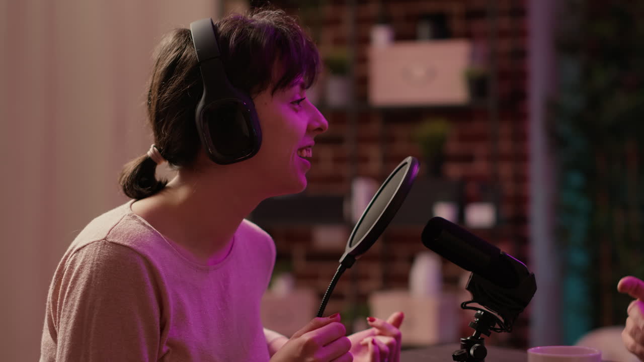 Static tripod shot of woman having casual converstion using professional microphone