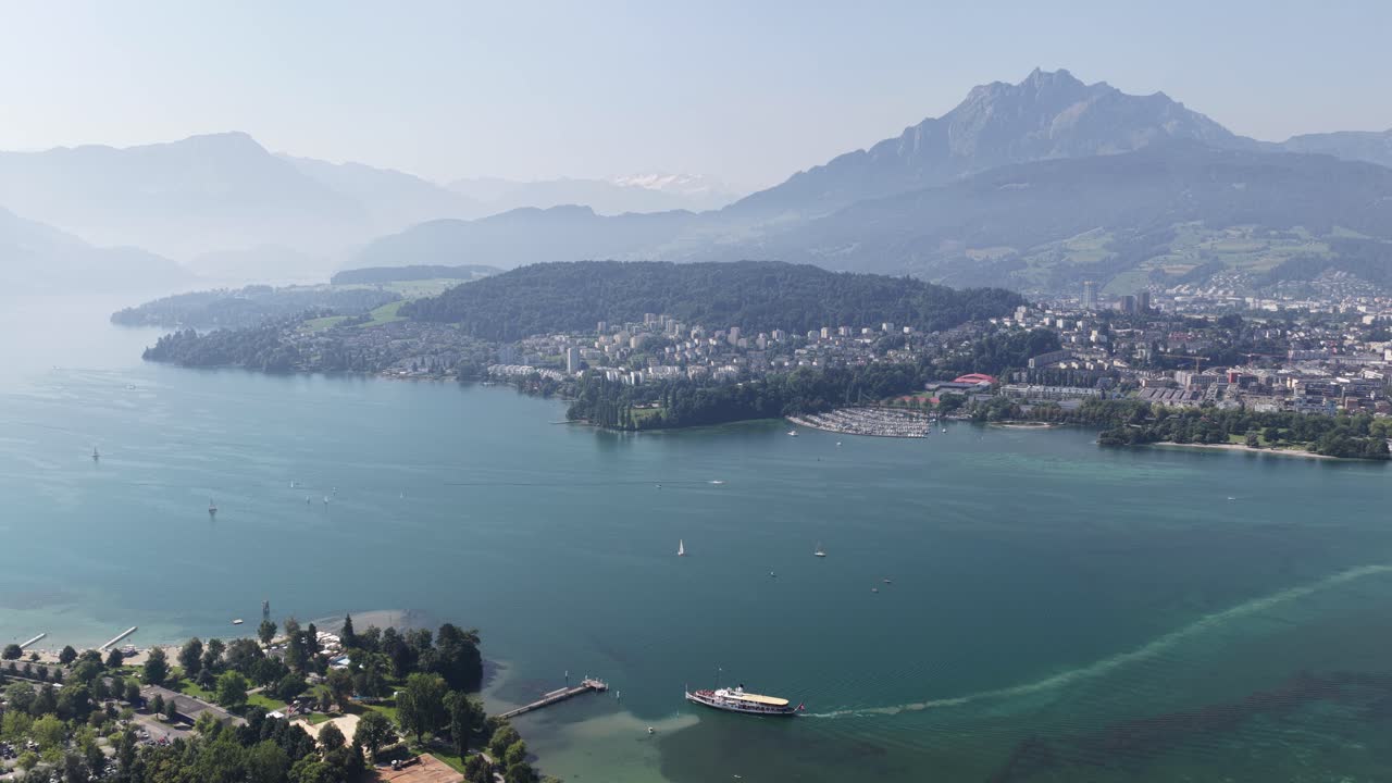 Revealing view of Lucern, Switzerland, Alps in the background. City skyline views