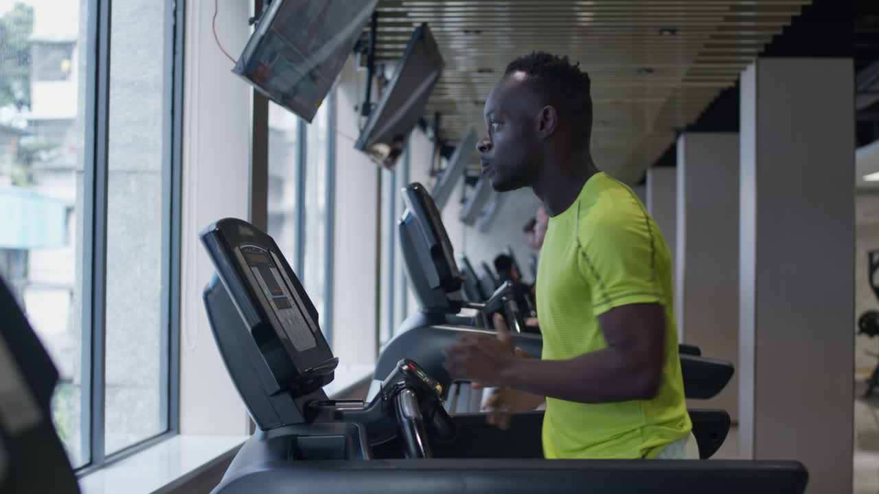 Man Running on Treadmill in Gym