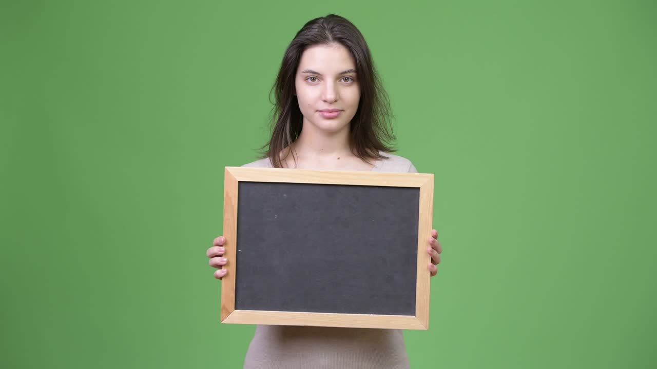 Young beautiful woman holding blackboard