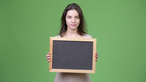 young beautiful woman holding blackboard