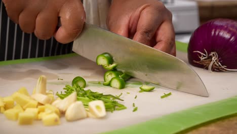 chopping serrano peppers with ginger and garlic cloves - chana masala series