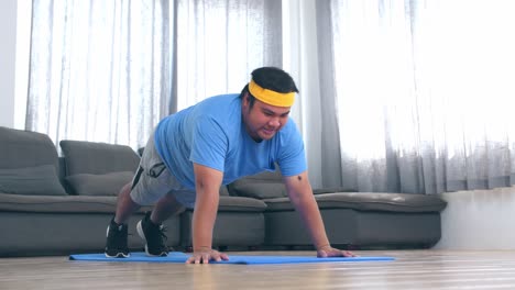 fat man is doing push ups at home