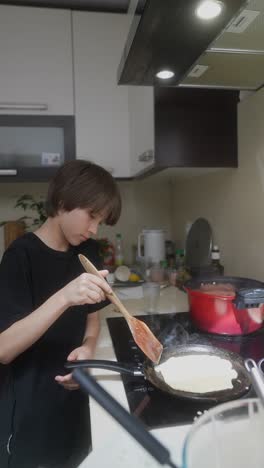 child cooking pancakes