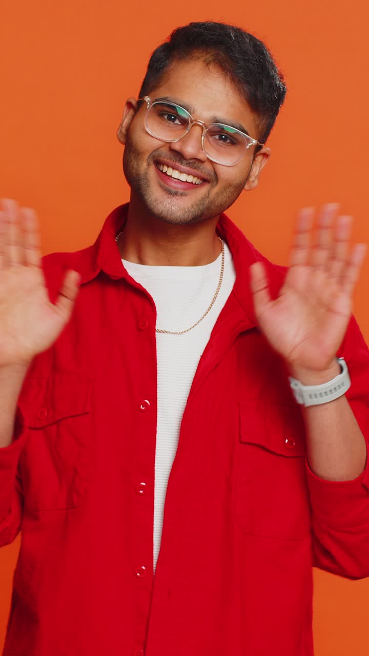 Happy man smiling friendly waving hands gesturing hello greeting or goodbye meeting invitation