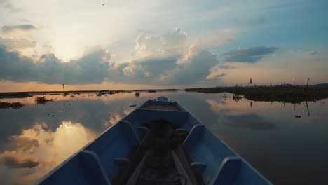 sunrise/sunset over a calm lake, with a boat