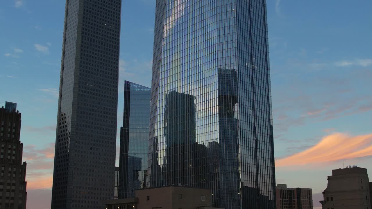 Aerial - Skyscrapers in Downtown Houston with reflections at dusk