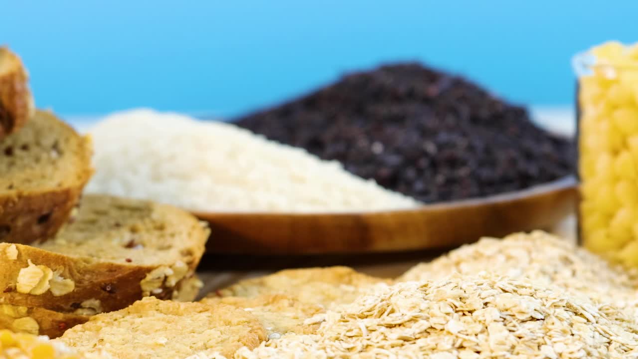 Various grains and bread slices with grains being poured, set against a bright blue background