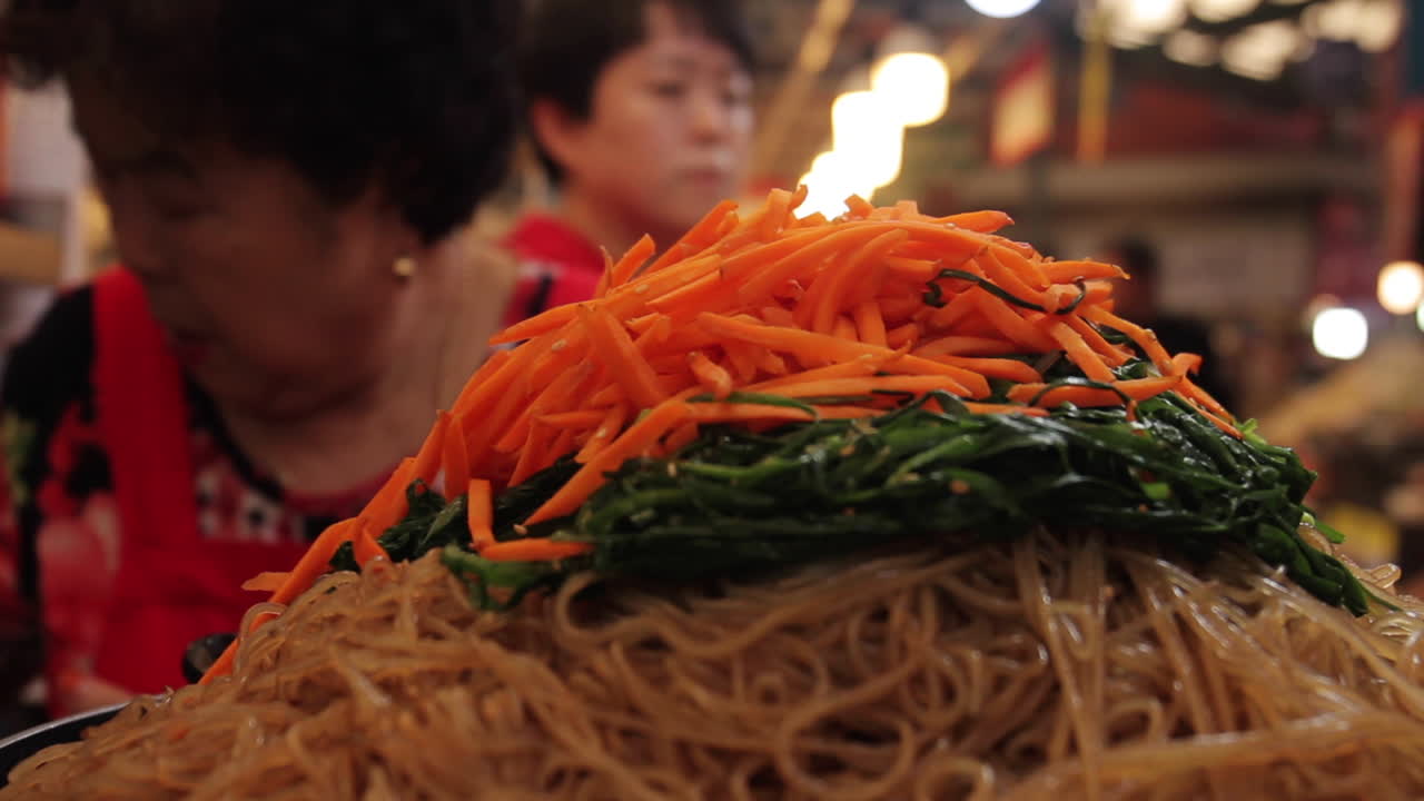 Korean Stir-fried Noodles with Carrots and Vegetables at a Market