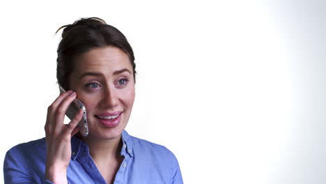 Studio-Shot-Of-Animated-Young-Woman-Talking-On-Mobile-Phone