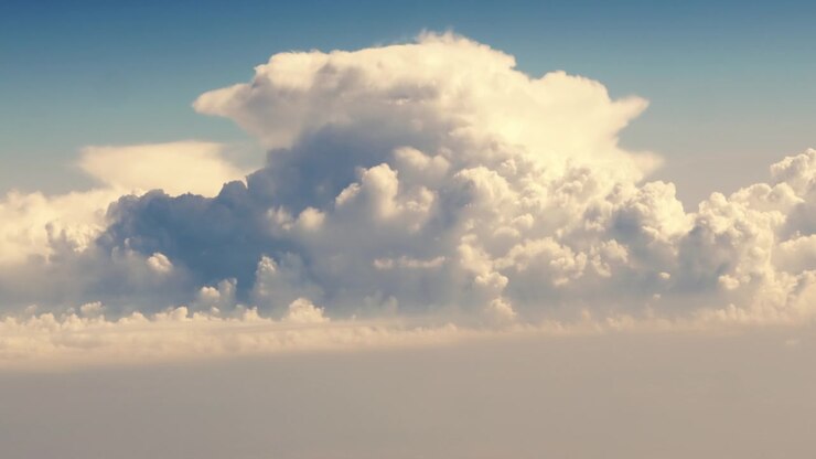 Dramatic Huge Clouds Towering Above Landscape. Taken from High Aerial Perspective.