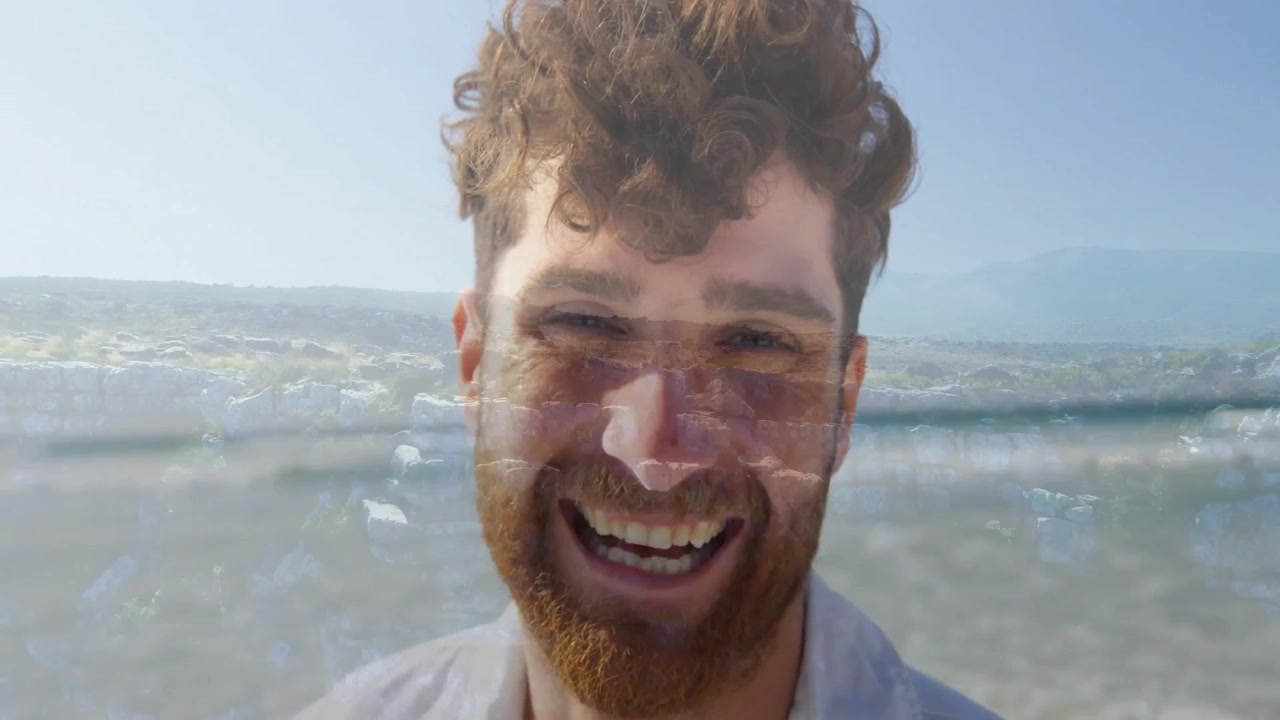 Double Exposure Portrait of a Smiling Man Overlaid with Ocean Waves