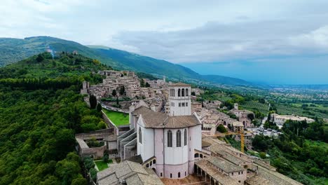 basilica of saint francis of assisi and hillside town in assisi, umbria, italy