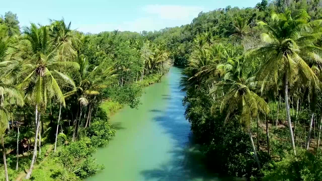 Drone flying over pristine Maron river in Pacitan, East Java, Indonesia. Aerial panoramic view