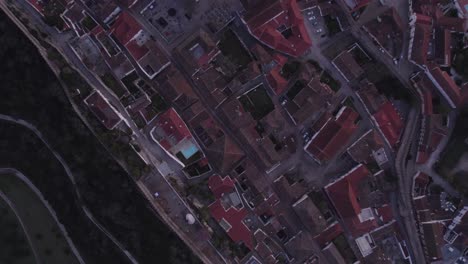 Top-down-of-Obidos-medieval-town-Portugal-during-sunrise,-aerial