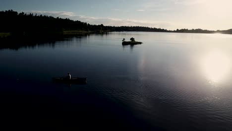 High-mountain-lake-being-navigated-by-a-canoe