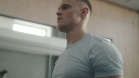 man doing bicep curls with ez bar in gym
