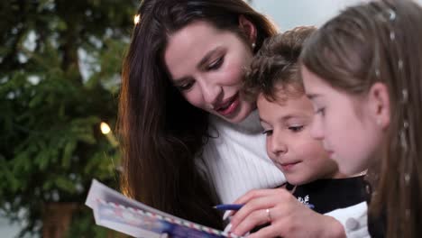 young mother with children she is having fun and writing a letter to santa claus young mother with children she is having fun and writing a letter to santa claus happy smiling family