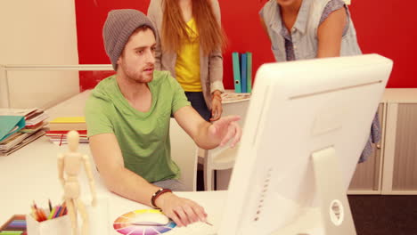 Fashion students working together on computer