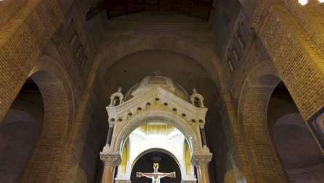 solemn interior of the catedral metropolitana, medellin, with its iconic crucifix and arched brickwork, embodying serene spirituality