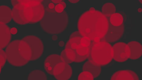luces bokeh rojas llamativas que crean contraste en el lienzo negro profundo