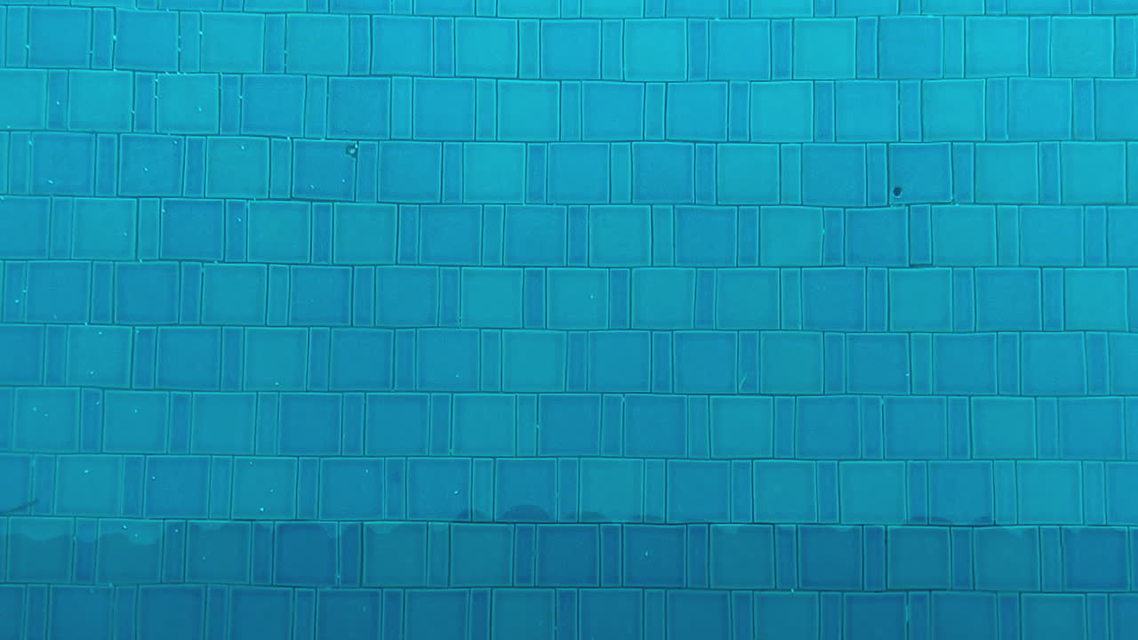 Swimming pool blue water with tile pattern background in clean outdoor leisure setting