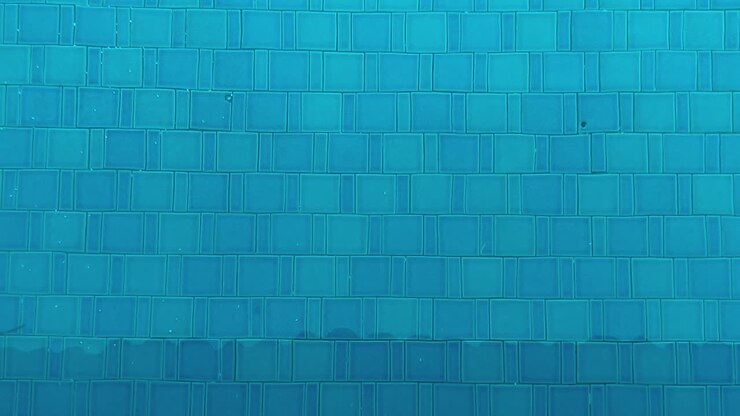 Swimming pool blue water with tile pattern background in clean outdoor leisure setting