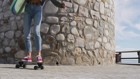 woman balancing on skateboard with surfboard at stone tower, displaying animated health chart