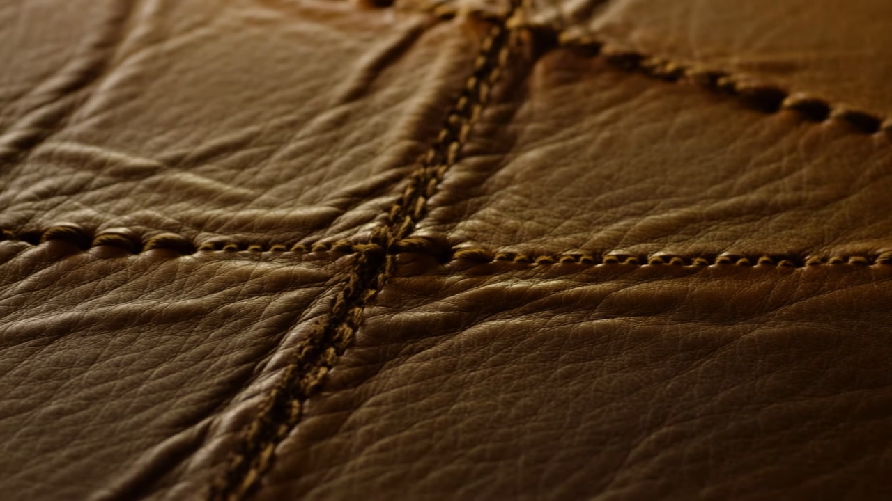 Closeup Brown Leather Stitching Detail Showing Rich Grain And Warm Lighting, Studio Shot Evokes Artisan