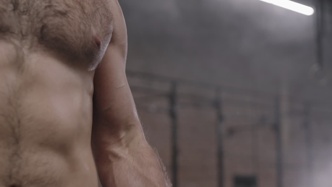 Unrecognizable Sportsman Lifting Dumbbell