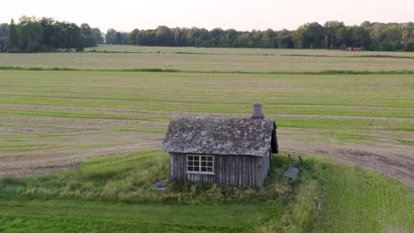 above view of abandoned blacksmith workshop amidst farmland in sweden. aerial drone shot
